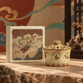 Flying Apsaras lidded incense diffuser beside its illustrated presentation box.
