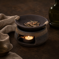Dry aromatic materials gently warmed in the upper ceramic bowl.