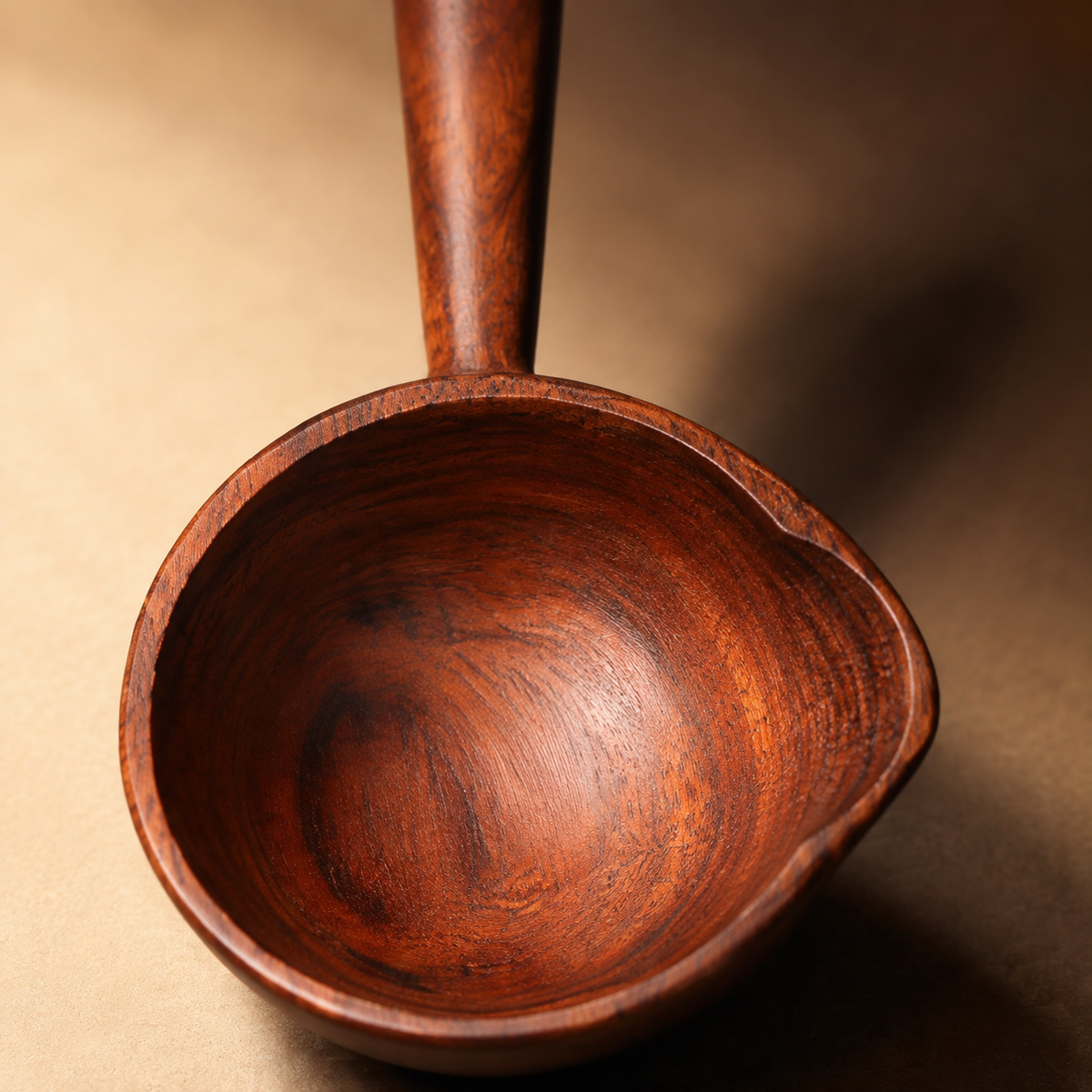 Close view of the acacia wood grain, rounded bowl and pouring lip.